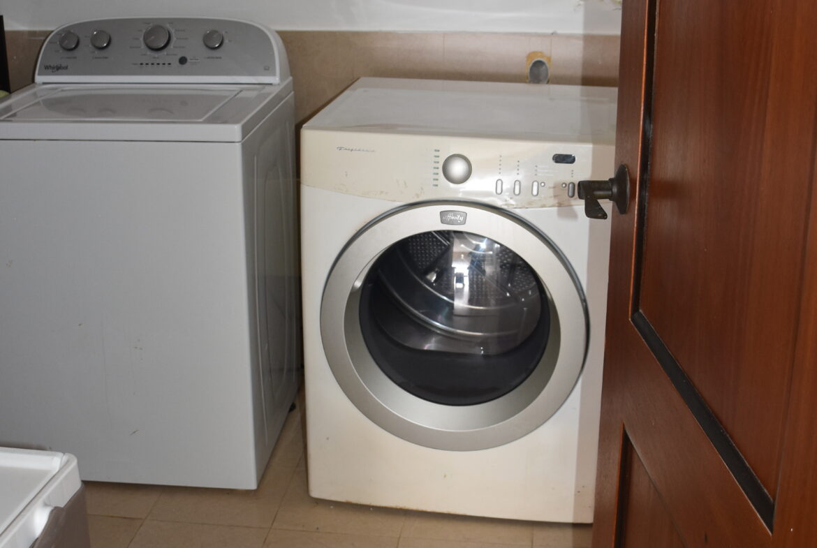 Laundry room with full-sized appliances.