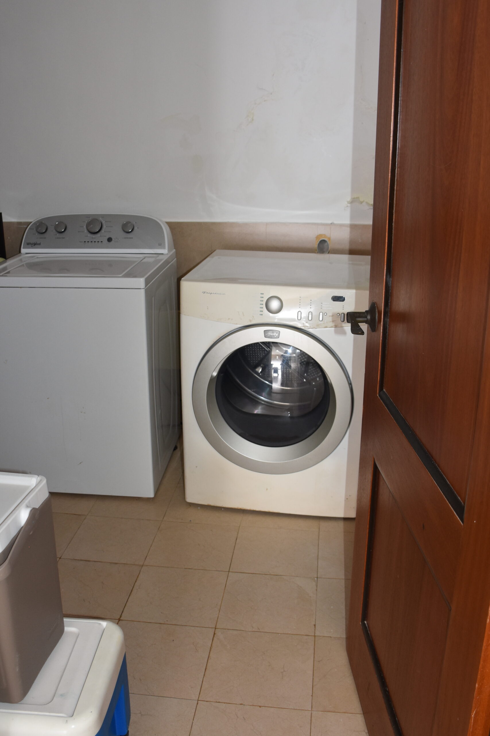 Laundry room with full-sized appliances.