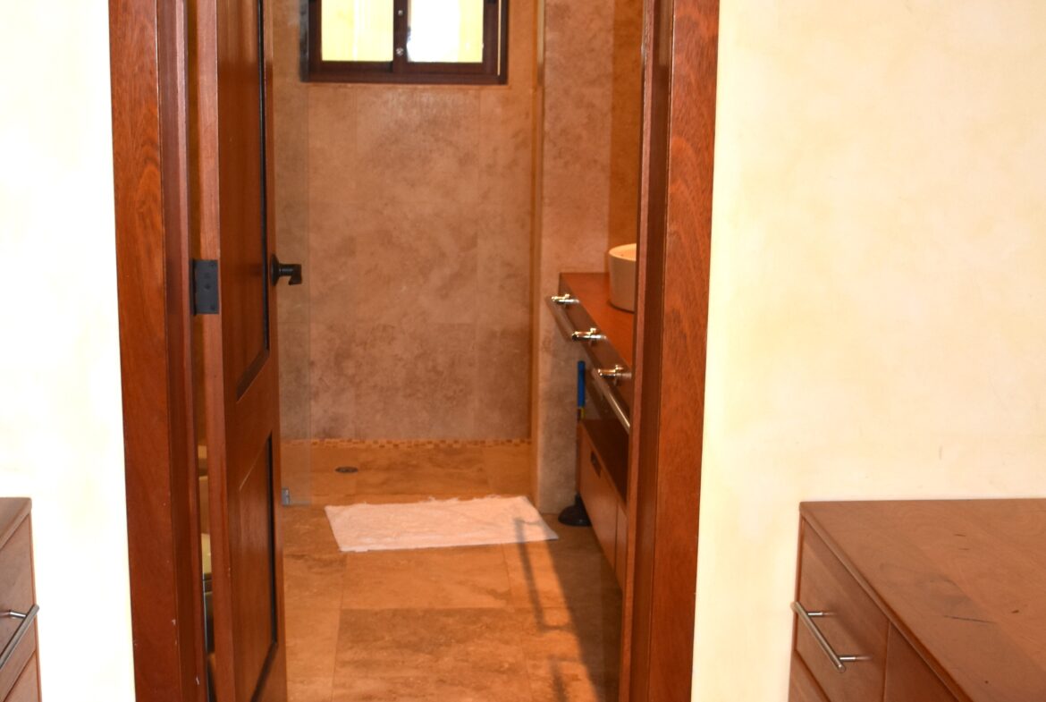 Spacious master closet leads to bath.