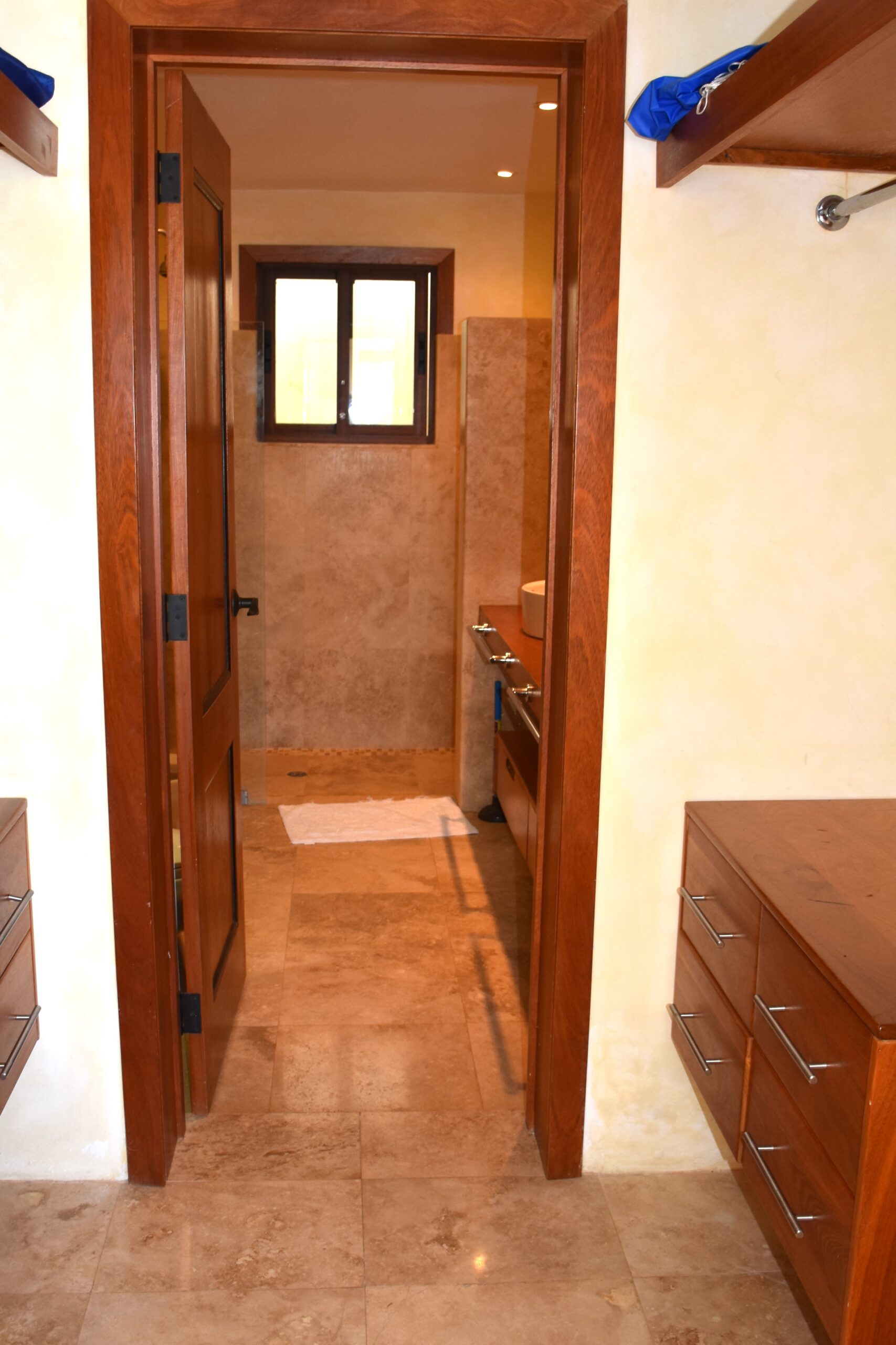 Spacious master closet leads to bath.
